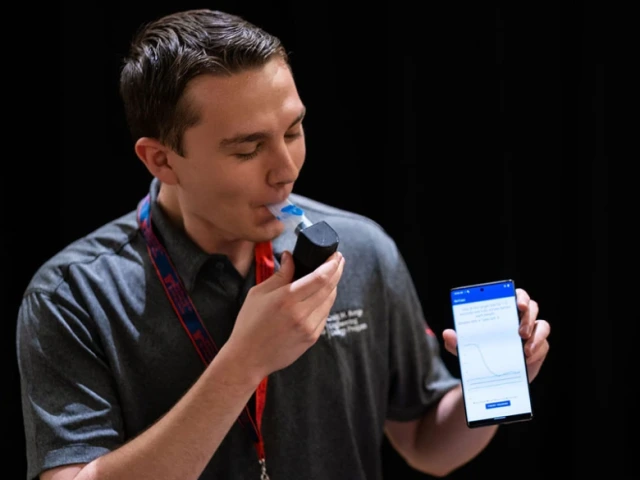 Capstone team member Nicholas Quatraro demonstrates the Inspiratory Muscle Strength Training (IMST) device at 2023 Craig M. Berge Design Day.