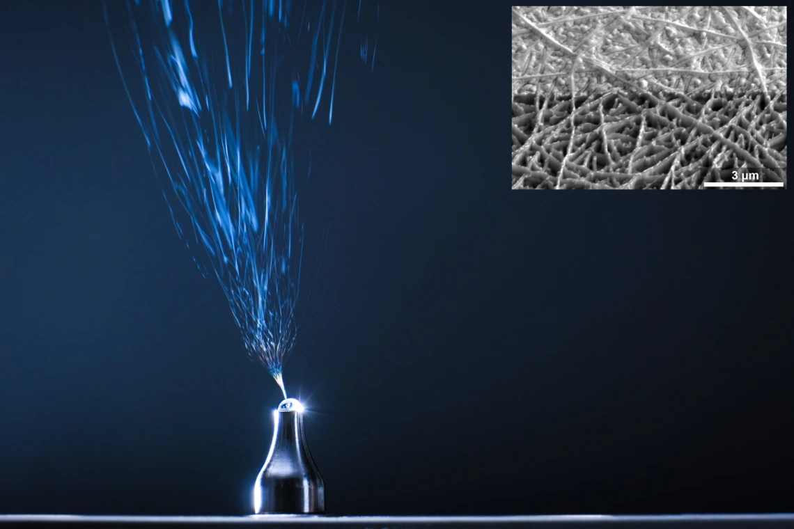 An image of a needle electrospinning fibers into solution-processed electronic thin films.