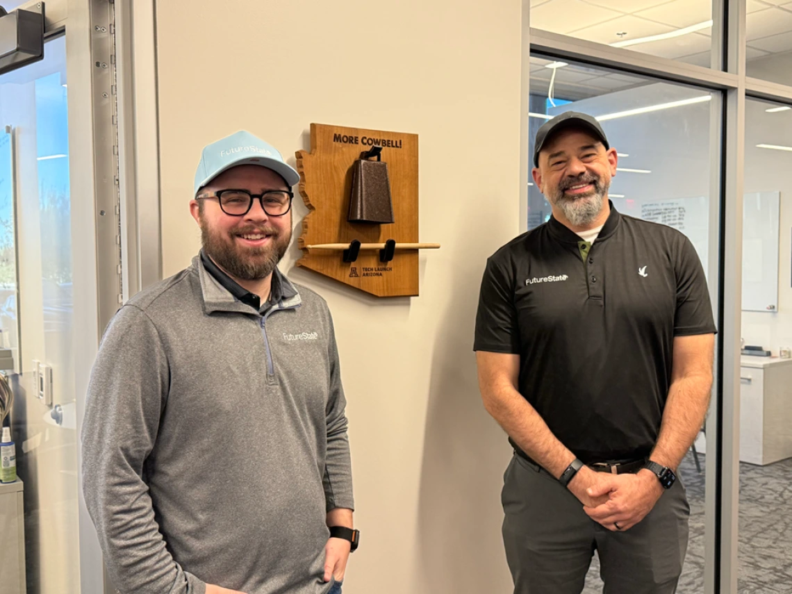 Chris Augustine and Joe Harting ring the Startup Cowbell at Tech Launch Arizona, a TLA tradition recognizing new startups that are launched to commercialize U of A inventions. 