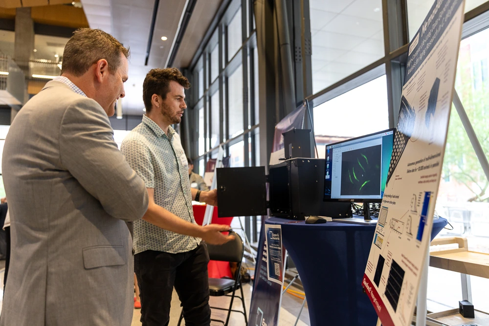 Attendees peruse expo tables at I-Squared 2025.