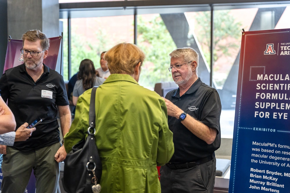 Attendees peruse expo tables at I-Squared 2025.